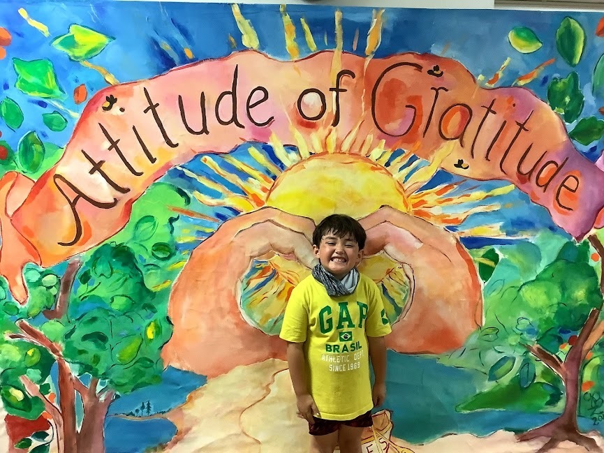 One at a time, students posed in front of the mural designated to the School theme, “Attitude of Gratitude.”